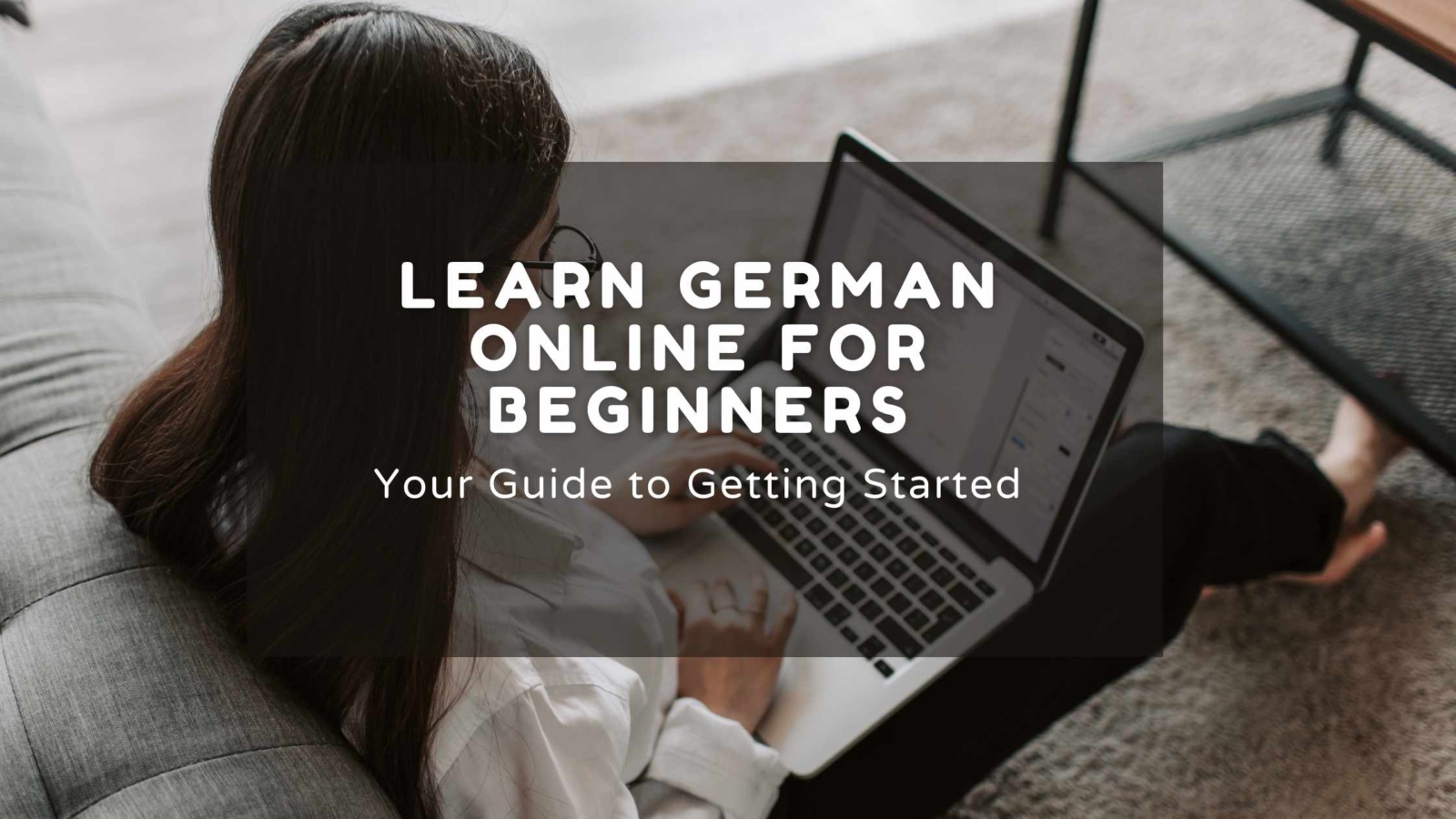 Person sitting on couch using laptop to learn German online, with text overlay 'LEARN GERMAN ONLINE FOR BEGINNERS: Your Guide to Getting Started